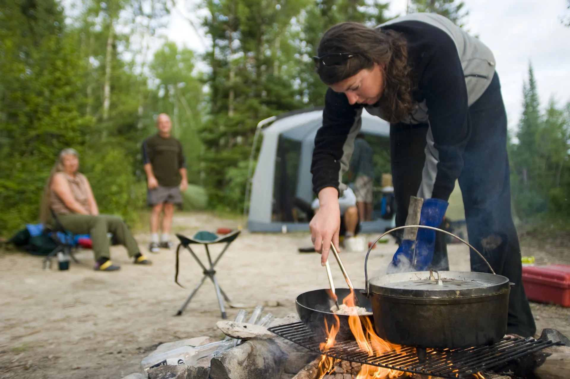 Campers cooking over open fire